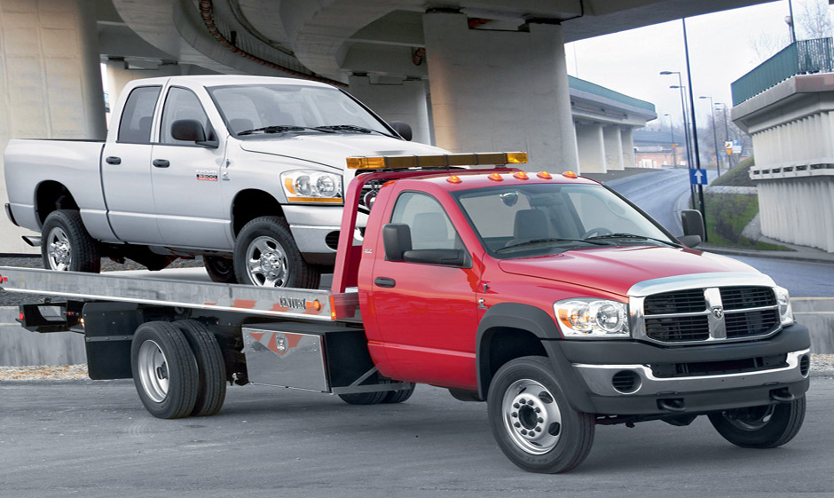 Photo of Red Dodge Ram flatbed towing truck with Pickup Truck in it. Photo of Red Dodge Ram flatbed towing truck with Pickup Truck in it.